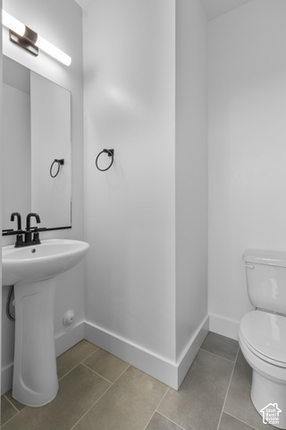 249 West 2920th Street South Logan, UT 84321 - Photo 9 of 23 Pedestal sink with a black-finish faucet, rectangular mirror, and matte black lighting fixture