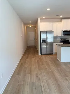 a kitchen with stainless steel appliances a refrigerator and a stove top oven