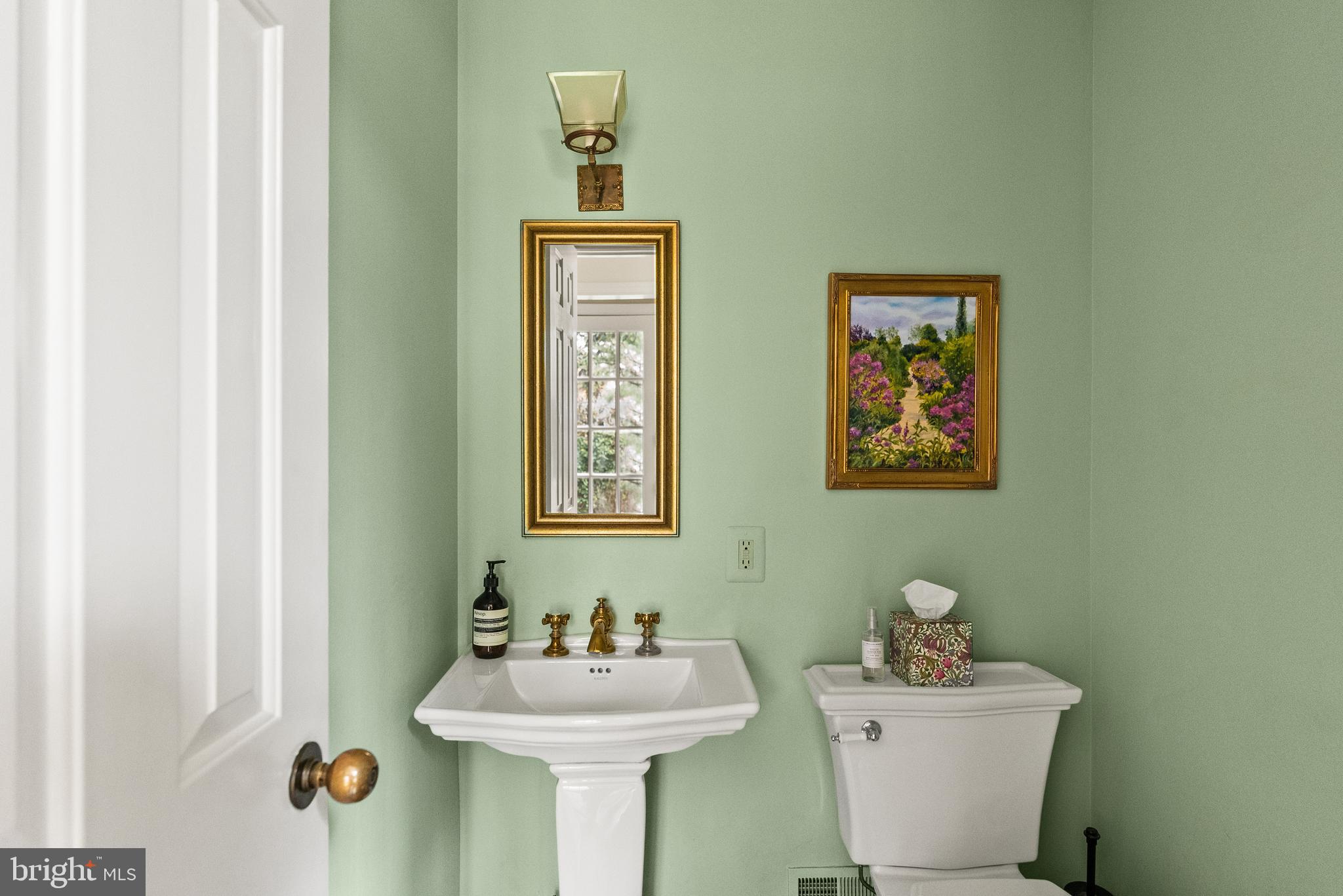 5202 Portsmouth Road Bethesda, MD 20816 - Photo 20 of 43 a bathroom with a sink mirror and toilet