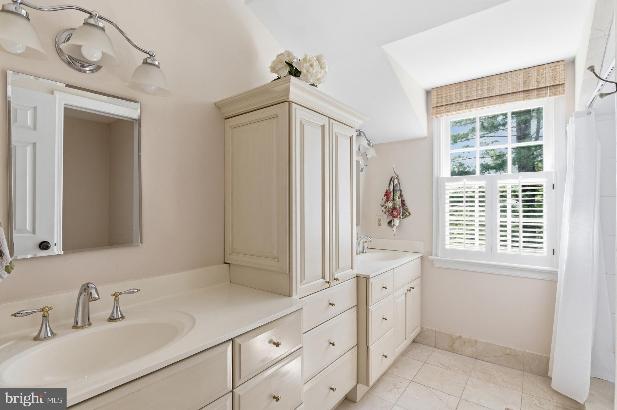 5202 Portsmouth Road Bethesda, MD 20816 - Photo 25 of 43 a bathroom with a sink a vanity and a mirror