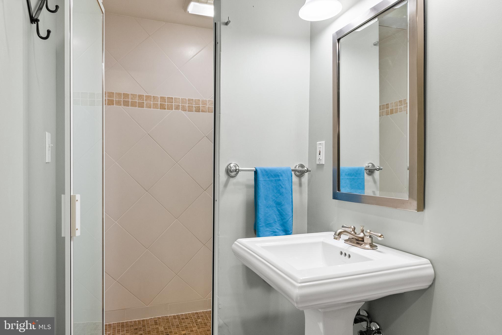 5202 Portsmouth Road Bethesda, MD 20816 - Photo 33 of 43 a bathroom with a sink a mirror and a toilet