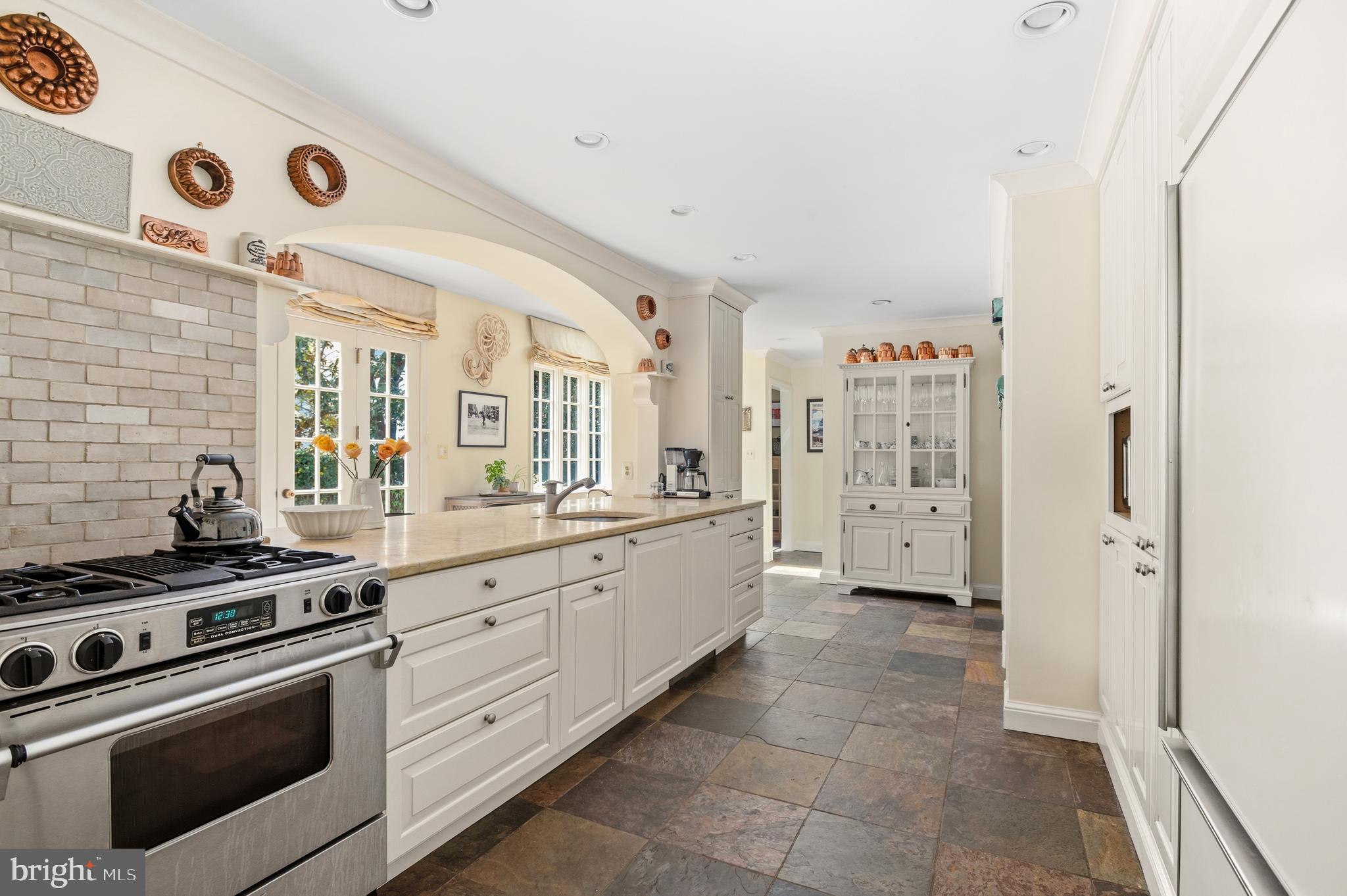 5202 Portsmouth Road Bethesda, MD 20816 - Photo 6 of 43 a large white kitchen with a stove and a refrigerator