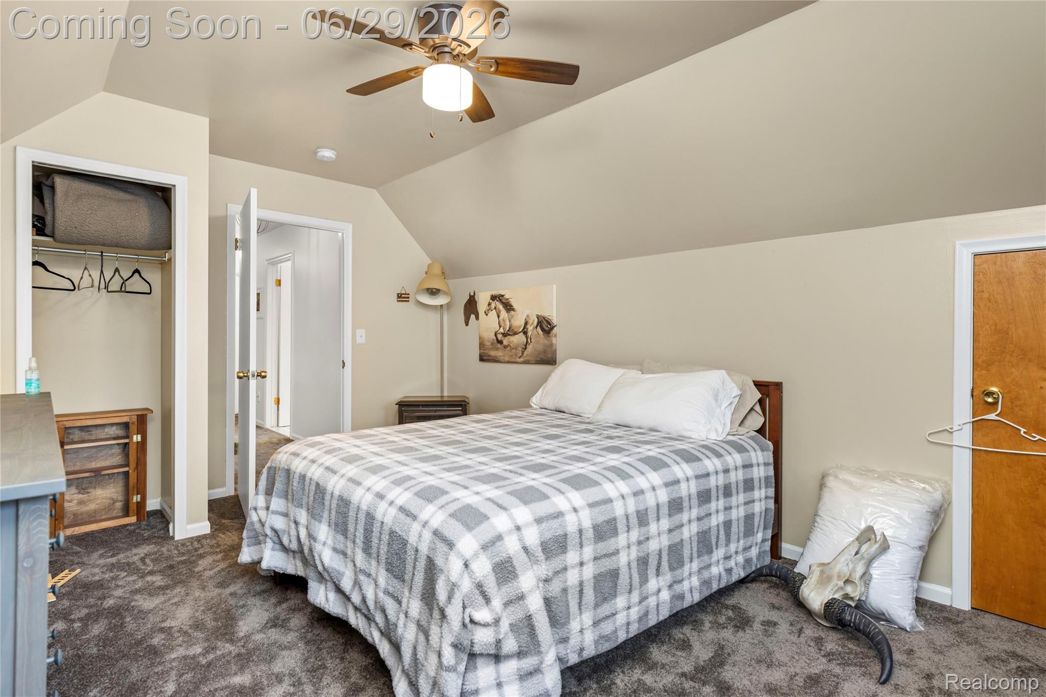 6085 Worlington Road Bloomfield Hills, MI 48301 - Photo 53 of 75 Carpeted room featuring a ceiling fan with integrated lighting, a built-in closet with hanging rod, and a solid wood door
