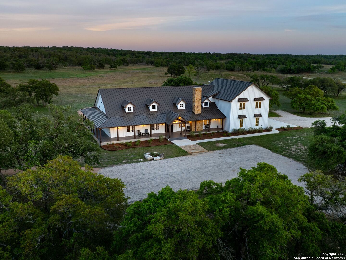 an aerial view of a house with big yard