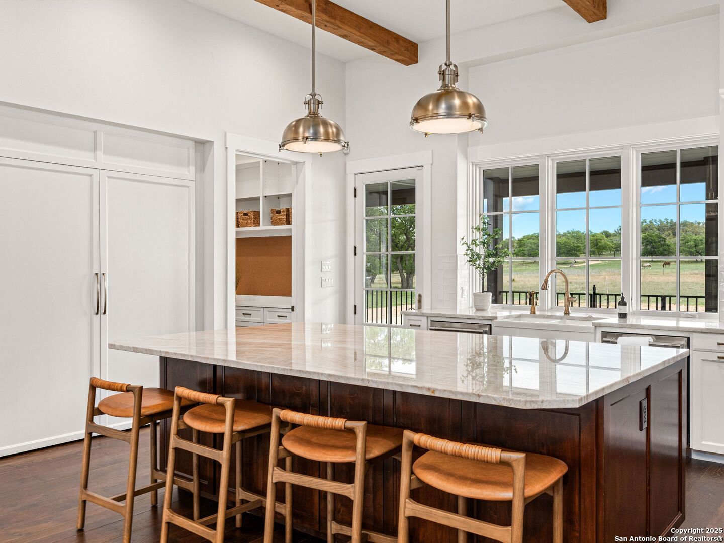 862 Grape Creek Road Fredericksburg, TX 78624 - Photo 22 of 90 a view of a dining room with furniture large windows and wooden floor