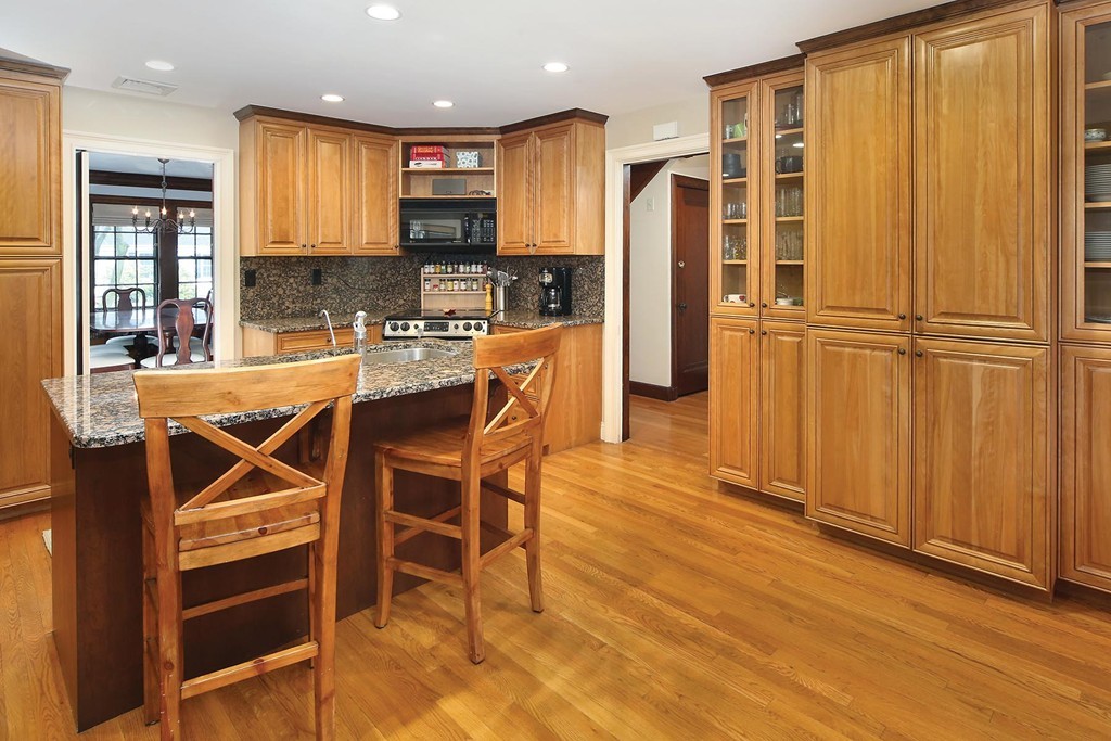 49 Olde Field Road Newton, MA 02459 - Photo 4 of 12 a kitchen with stainless steel appliances a refrigerator and wooden cabinets