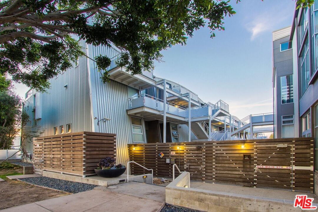 a front view of a house with a tree