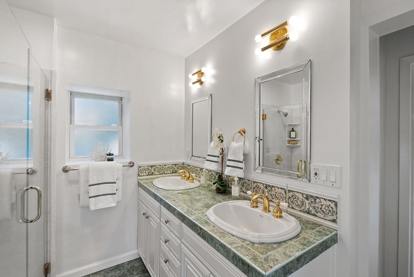 807 Cañada Road Woodside, CA 94062 - Photo 27 of 35 a bathroom with a granite countertop sink a mirror and a shower