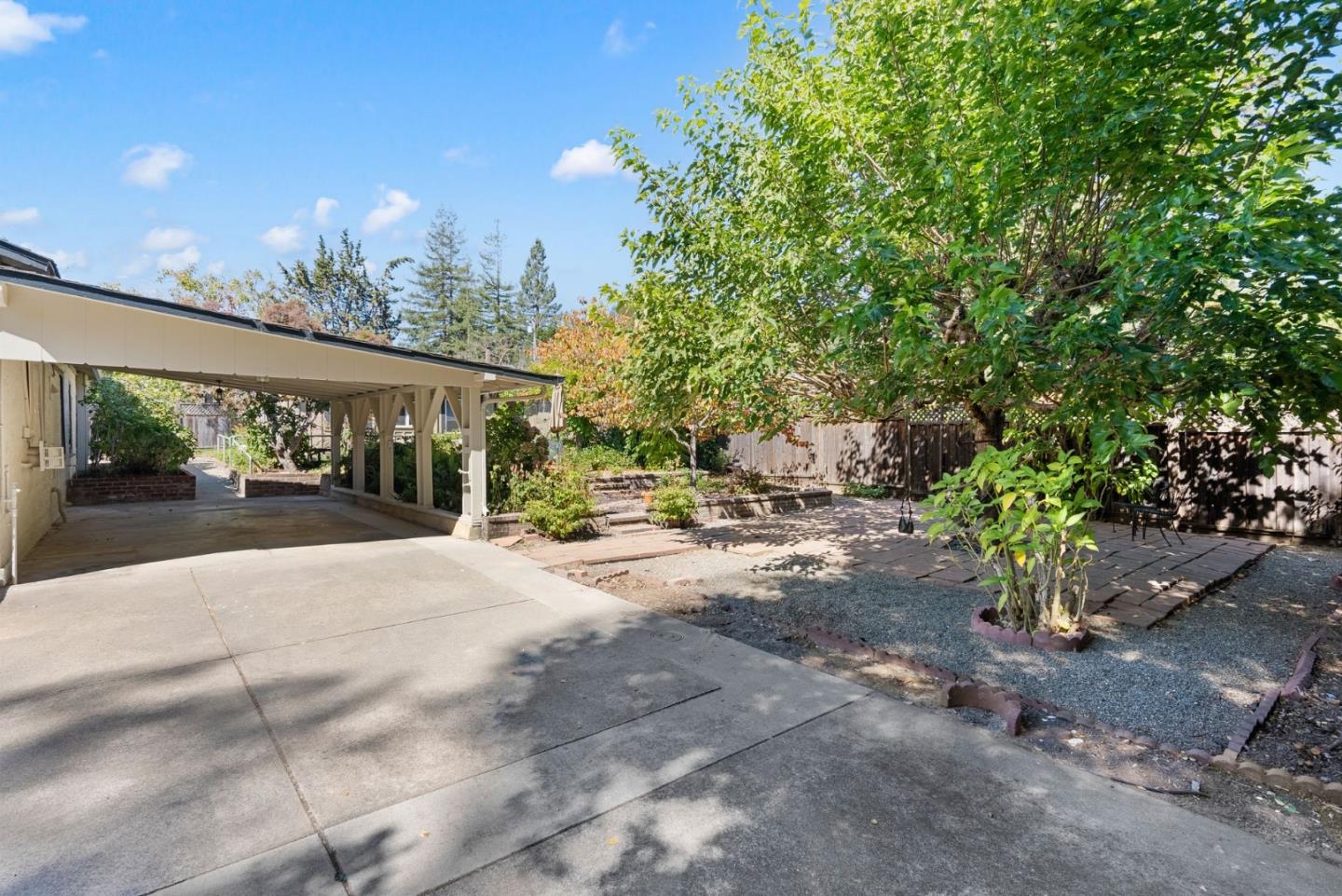 807 Cañada Road Woodside, CA 94062 - Photo 32 of 35 a patio with table and chairs and potted plants