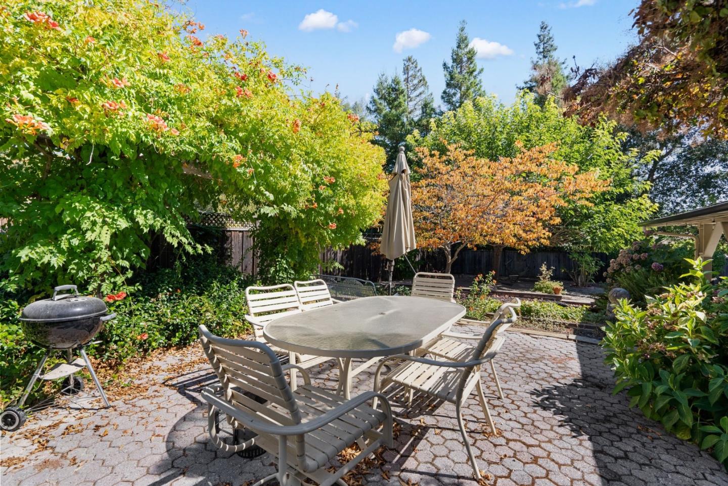 807 Cañada Road Woodside, CA 94062 - Photo 34 of 35 a backyard of a house with table and chairs