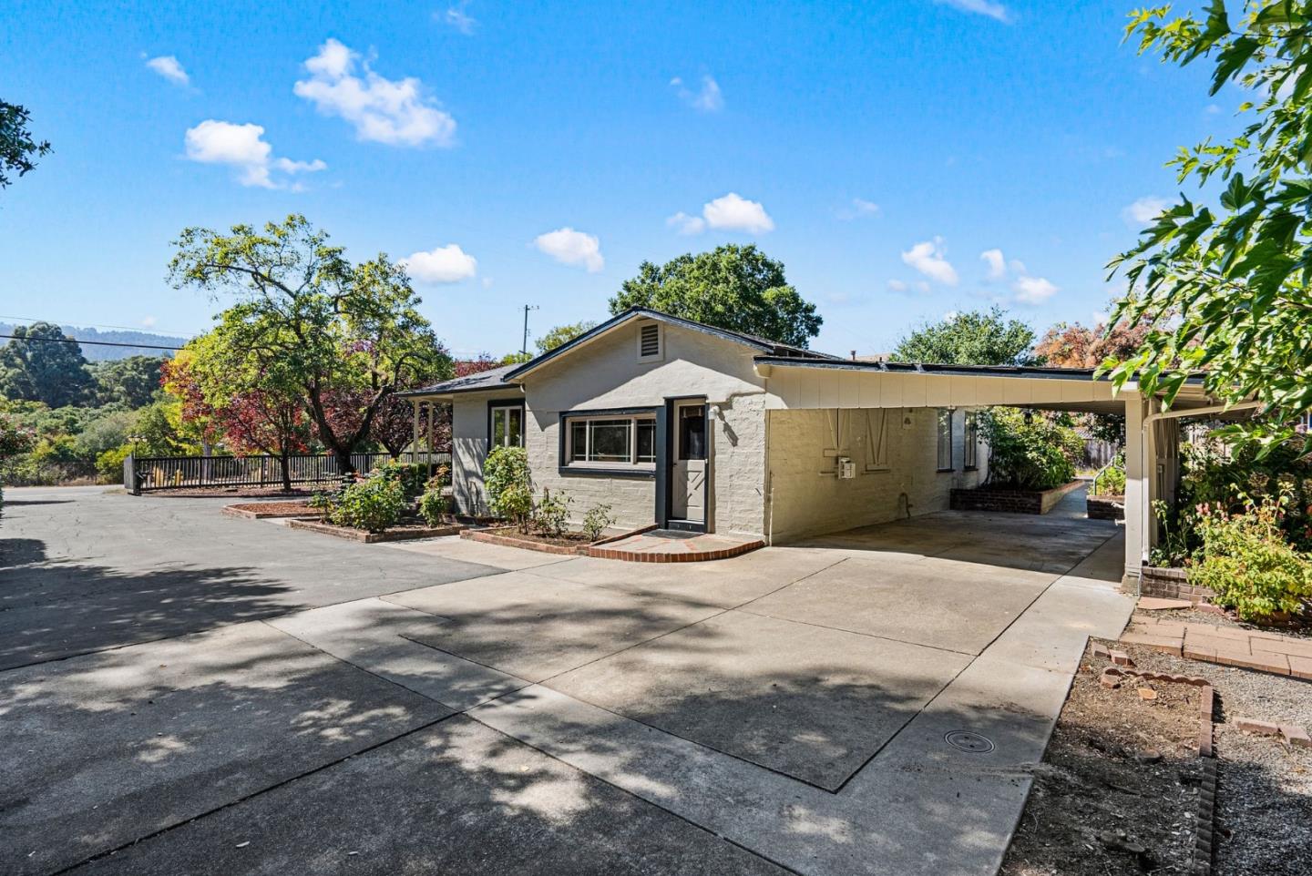 807 Cañada Road Woodside, CA 94062 - Photo 8 of 35 a front view of a house with a yard and garage