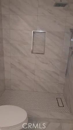 a bathroom with a toilet and a shower
