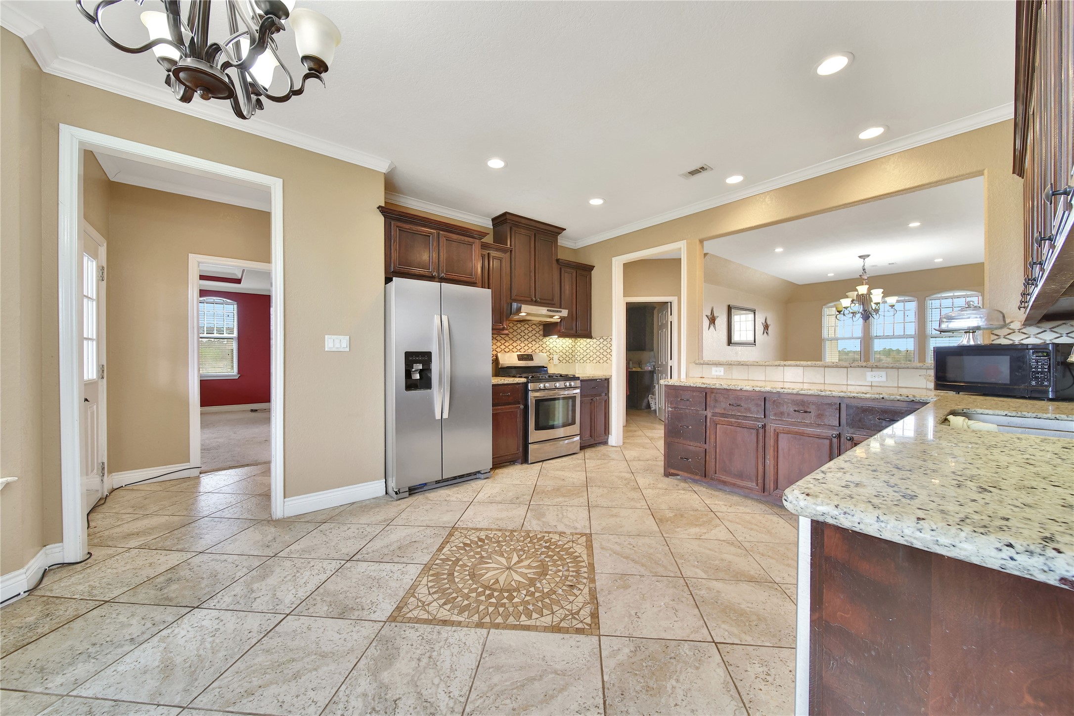 22 O'Bannon Ranch Road Huntsville, TX 77320 - Photo 12 of 31 a large kitchen with kitchen island granite countertop a large counter top and stainless steel appliances
