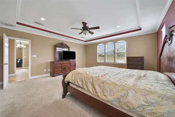 a spacious bathroom with a granite countertop sink a toilet a mirror and vanity