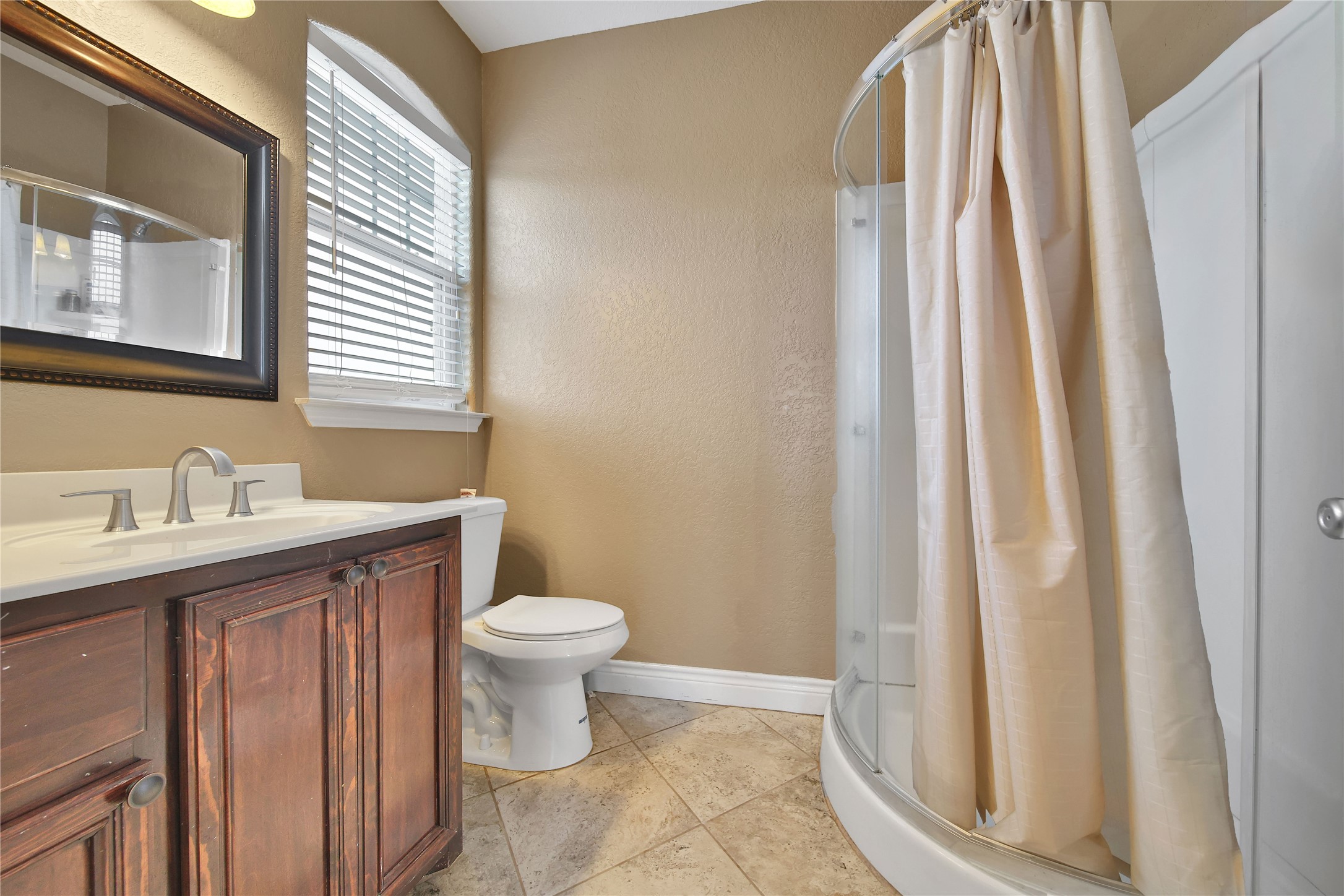 22 O'Bannon Ranch Road Huntsville, TX 77320 - Photo 21 of 31 a bathroom with a sink a toilet and shower curtain