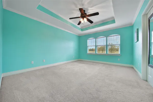 a view of a white house with a big yard and large trees