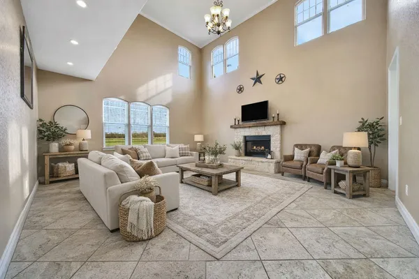 a living room with fireplace furniture and a flat screen tv