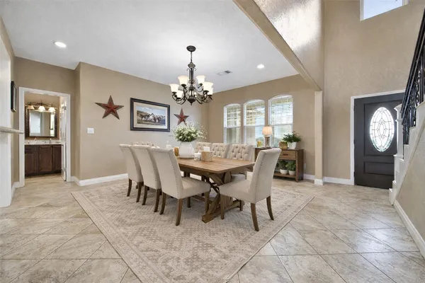 a view of a dining room with furniture and a chandelier