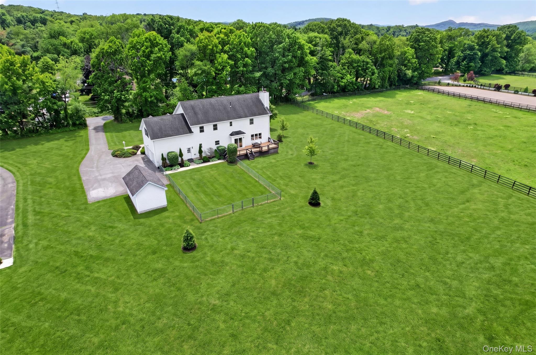 19 Bull Mine Road Chester, NY 10918 - Photo 37 of 42 Expansive green lawn surrounds a white two-story residence with a dark roof