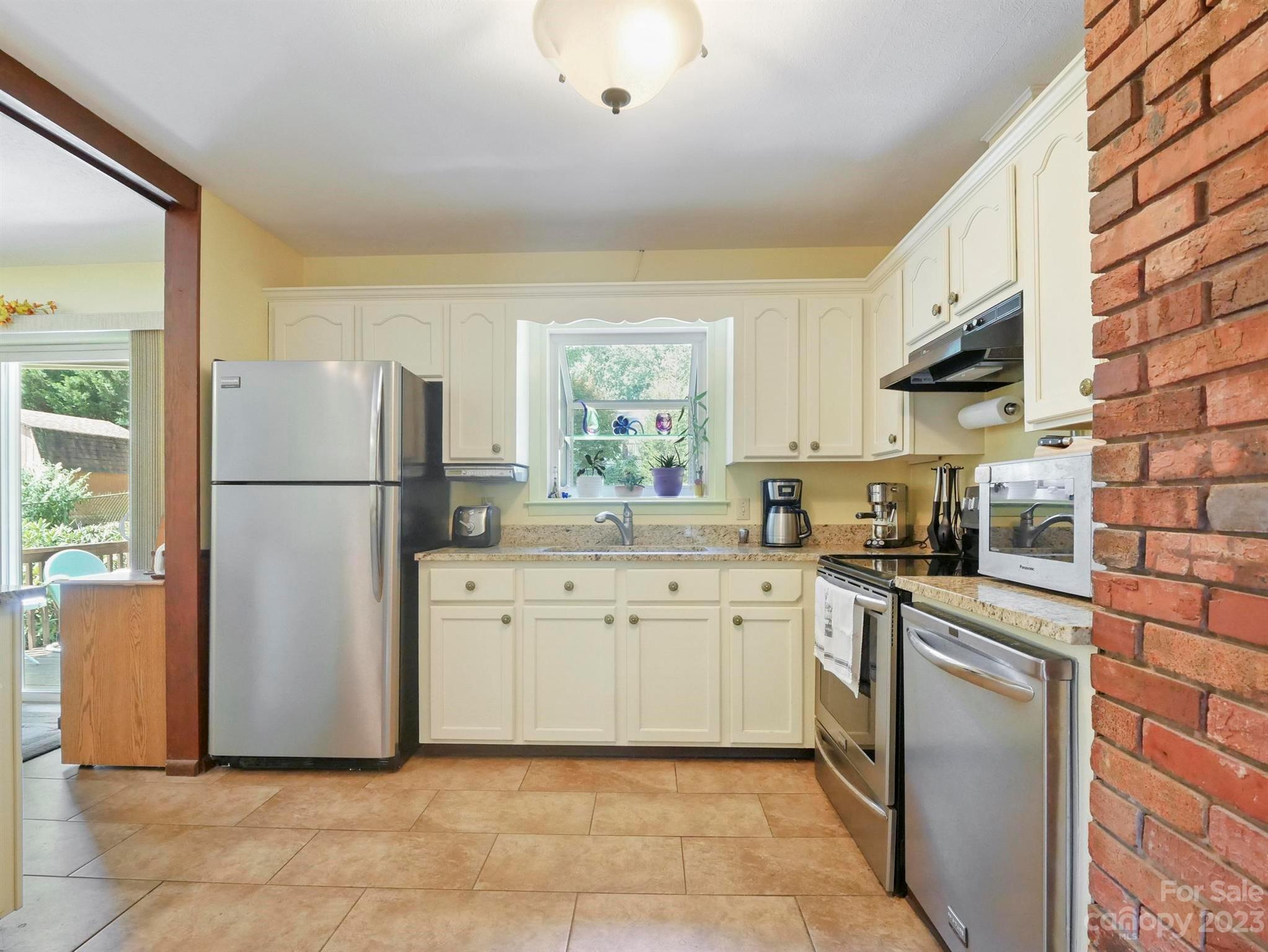 15 Oakbrook Road Fletcher, NC 28732 - Photo 6 of 37 a kitchen with stainless steel appliances granite countertop a refrigerator sink and stove