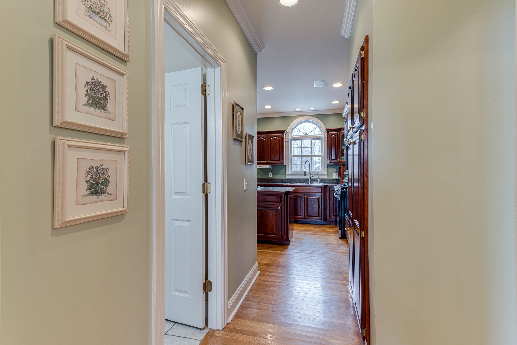 918 Urban Farms Road Manchester, TN 37355 - Photo 12 of 63 a view of a hallway with wooden floor and a kitchen