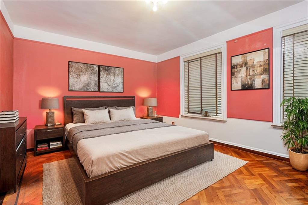 48 Hampton Place Brooklyn, NY 11213 - Photo 9 of 24 a bedroom with bed and paintings on the wall