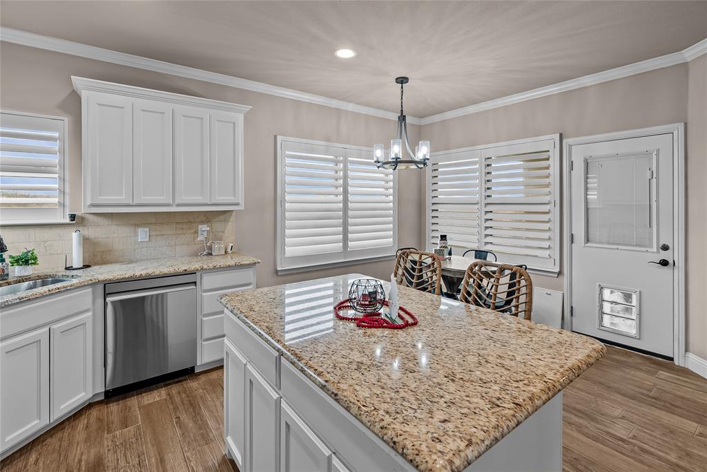 222 Rees Avenue Godley, TX 76044 - Photo 11 of 25 a kitchen with stainless steel appliances granite countertop a sink stove and cabinets
