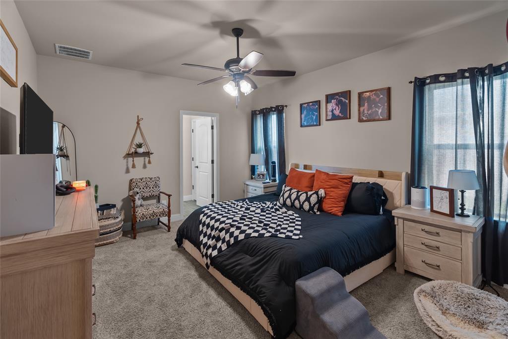 222 Rees Avenue Godley, TX 76044 - Photo 12 of 25 a bedroom with a bed and ceiling fan