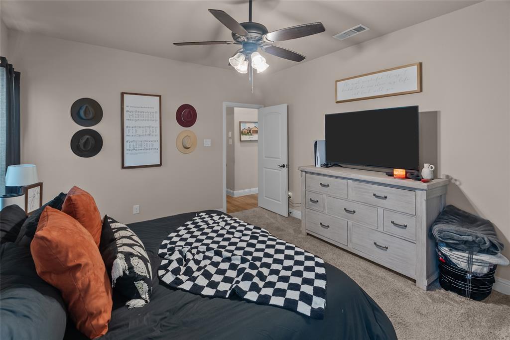 222 Rees Avenue Godley, TX 76044 - Photo 15 of 25 a bedroom with furniture and a flat screen tv