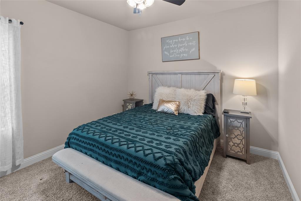 222 Rees Avenue Godley, TX 76044 - Photo 19 of 25 a bedroom with a bed and a night stand