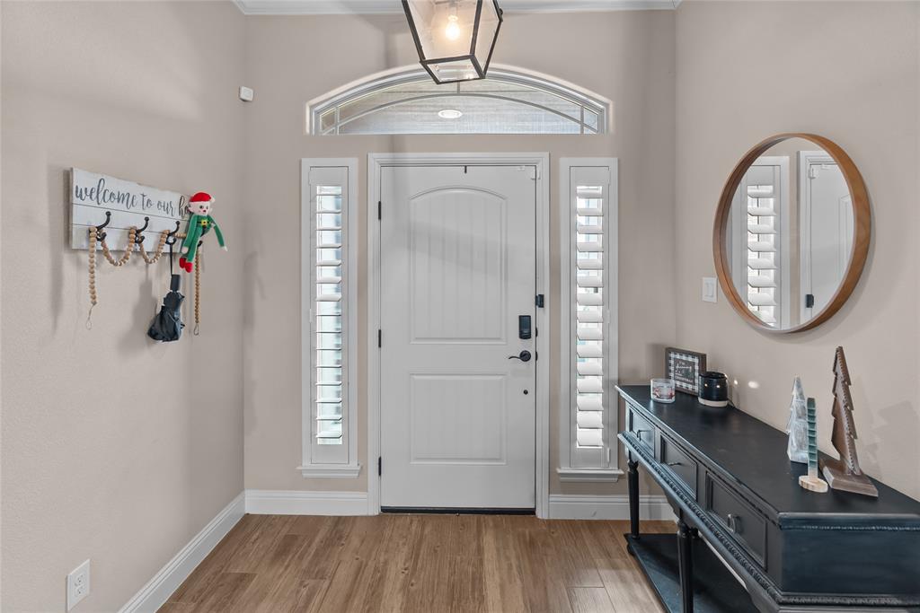 222 Rees Avenue Godley, TX 76044 - Photo 6 of 25 a view of a hallway with entryway wooden floor and front door