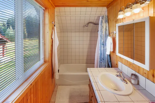 a bathroom with a bathtub and shower