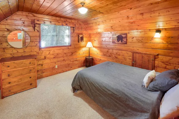 a bedroom with a bed and a mirror