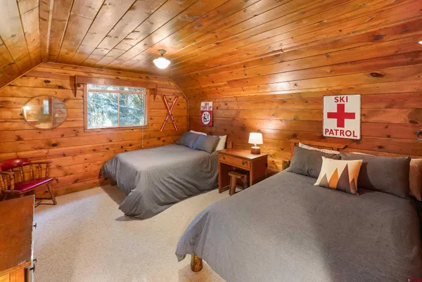 a bedroom with two beds and painted walls