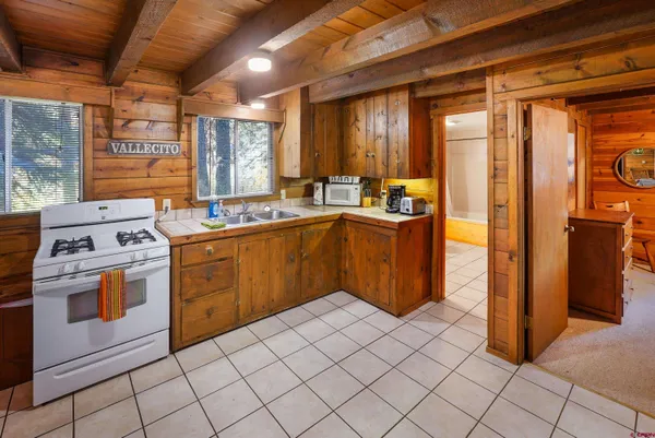a kitchen with a stove a sink and a refrigerator