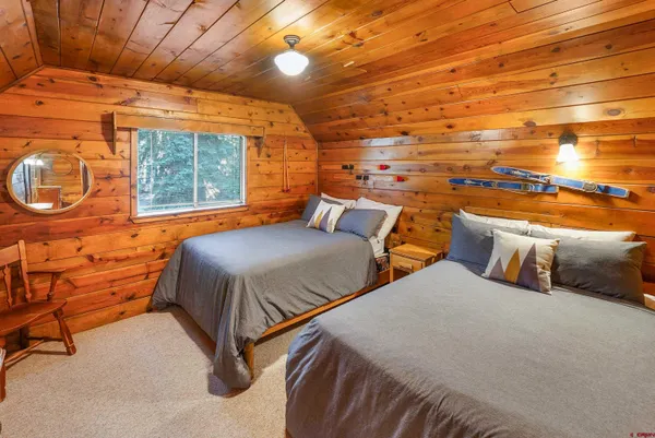 a bedroom with two beds and a window