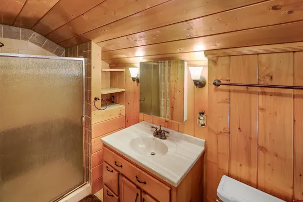 a bathroom with a sink a toilet and shower
