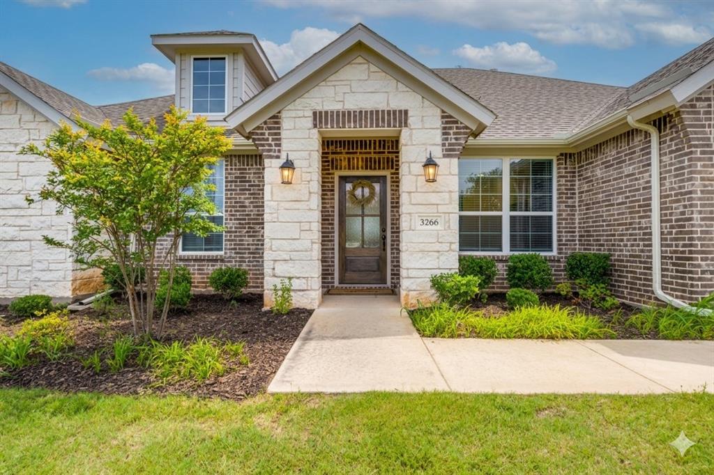 1933 Franklin Road Tom Bean, TX 75090 - Photo 1 of 28 a front view of a house with garden