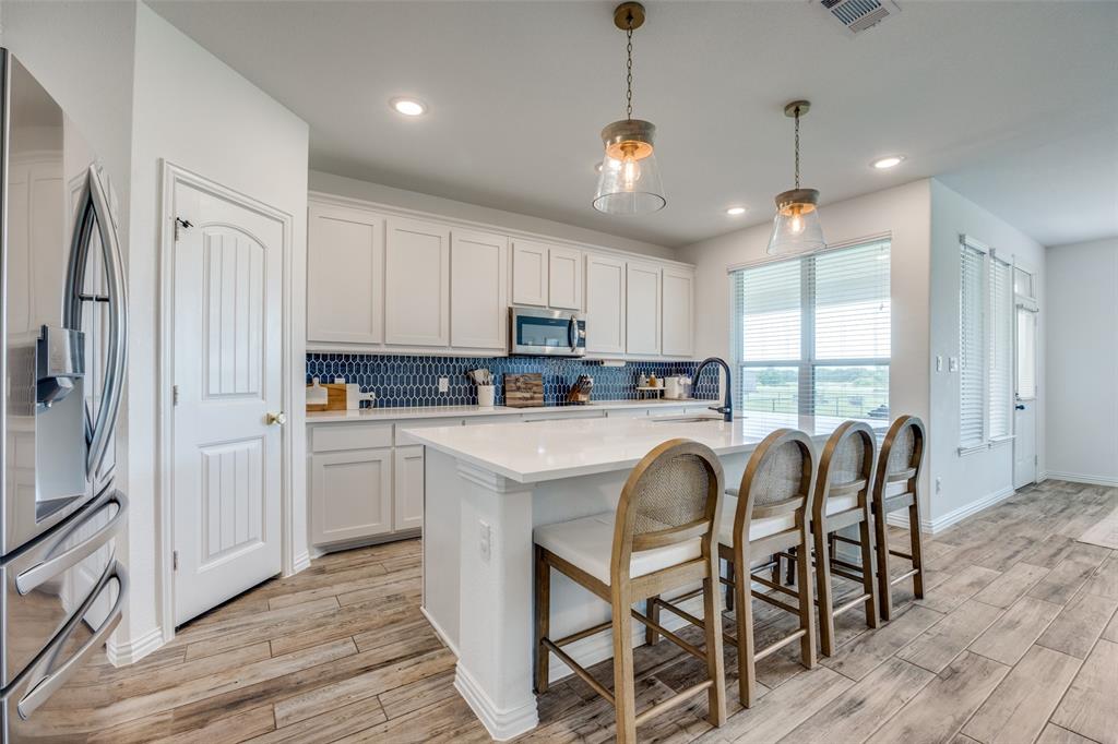 1933 Franklin Road Tom Bean, TX 75090 - Photo 12 of 28 a kitchen with stainless steel appliances granite countertop a stove a refrigerator a oven a sink with a dining table and chairs