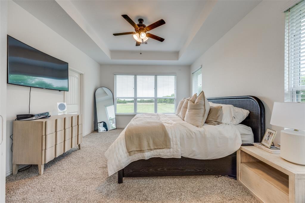 1933 Franklin Road Tom Bean, TX 75090 - Photo 17 of 28 a spacious bedroom with a bed and a large window