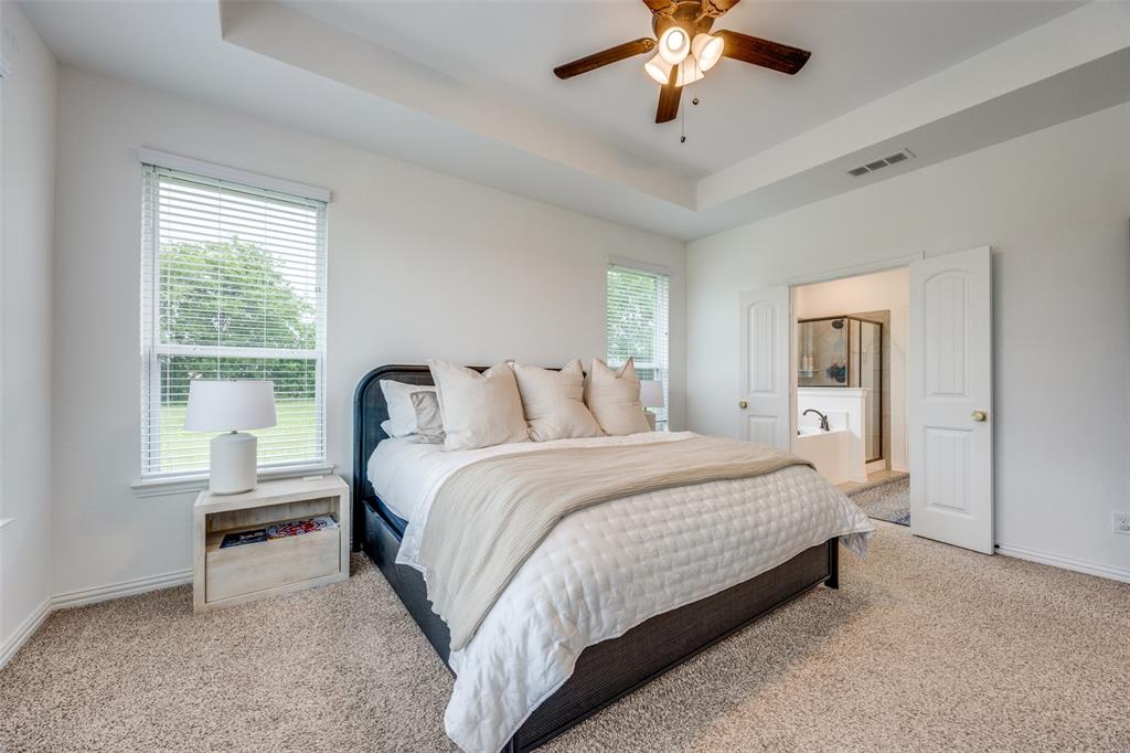 1933 Franklin Road Tom Bean, TX 75090 - Photo 18 of 28 a bedroom with a bed and a chandelier