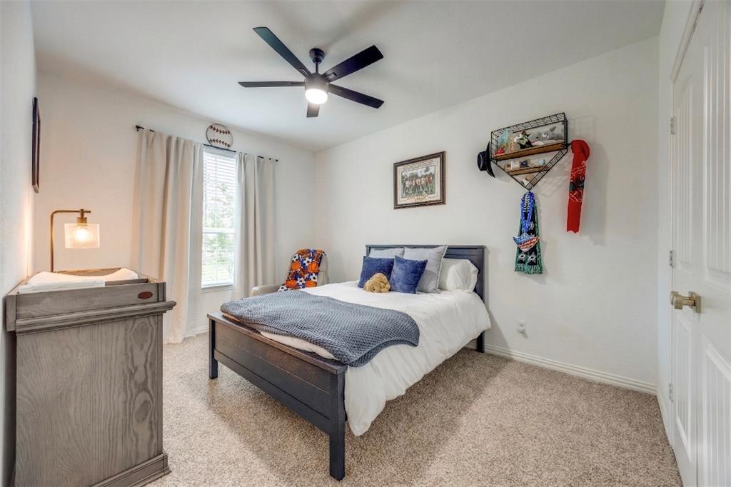 1933 Franklin Road Tom Bean, TX 75090 - Photo 23 of 28 a bedroom with a bed and a chandelier