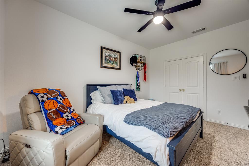 1933 Franklin Road Tom Bean, TX 75090 - Photo 24 of 28 a bedroom with a bed and a chandelier