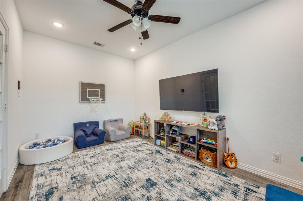 1933 Franklin Road Tom Bean, TX 75090 - Photo 10 of 28 a bedroom with furniture and a flat screen tv