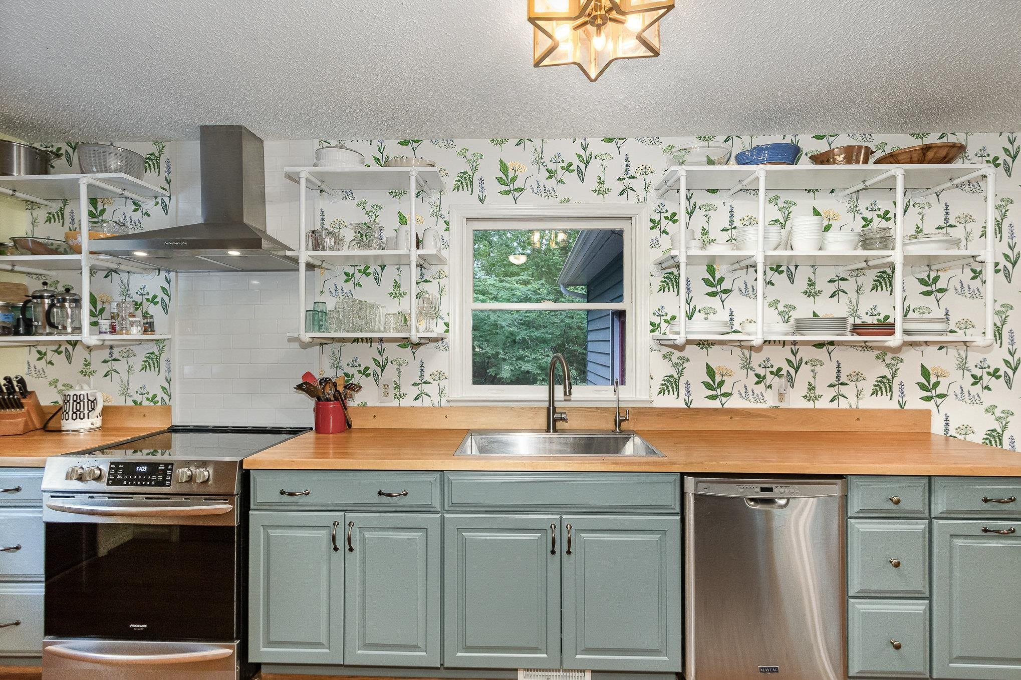 3200 Twin Streams Road Chapel Hill, NC 27516 - Photo 12 of 46 a kitchen with stainless steel appliances granite countertop a sink and a wooden floors