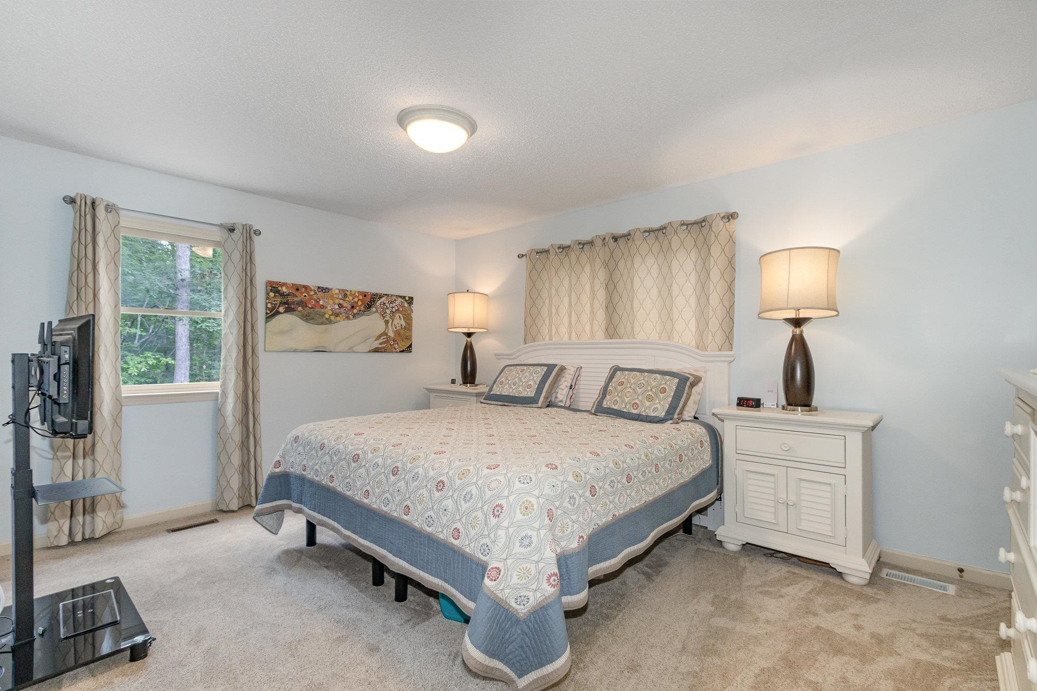 3200 Twin Streams Road Chapel Hill, NC 27516 - Photo 19 of 46 a spacious bedroom with a bed and a large window