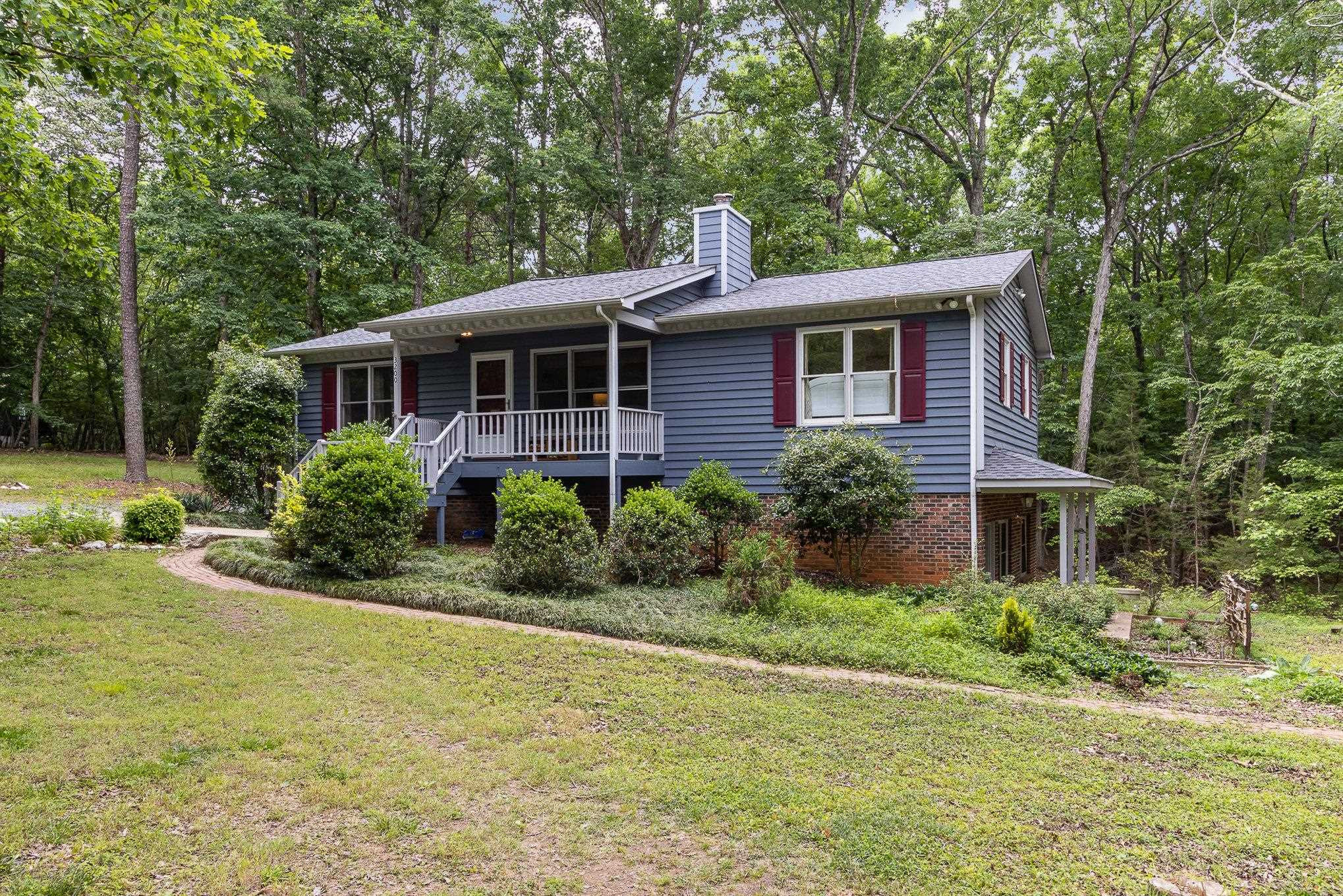 3200 Twin Streams Road Chapel Hill, NC 27516 - Photo 2 of 46 a view of a house in front of a yard with plants and large trees