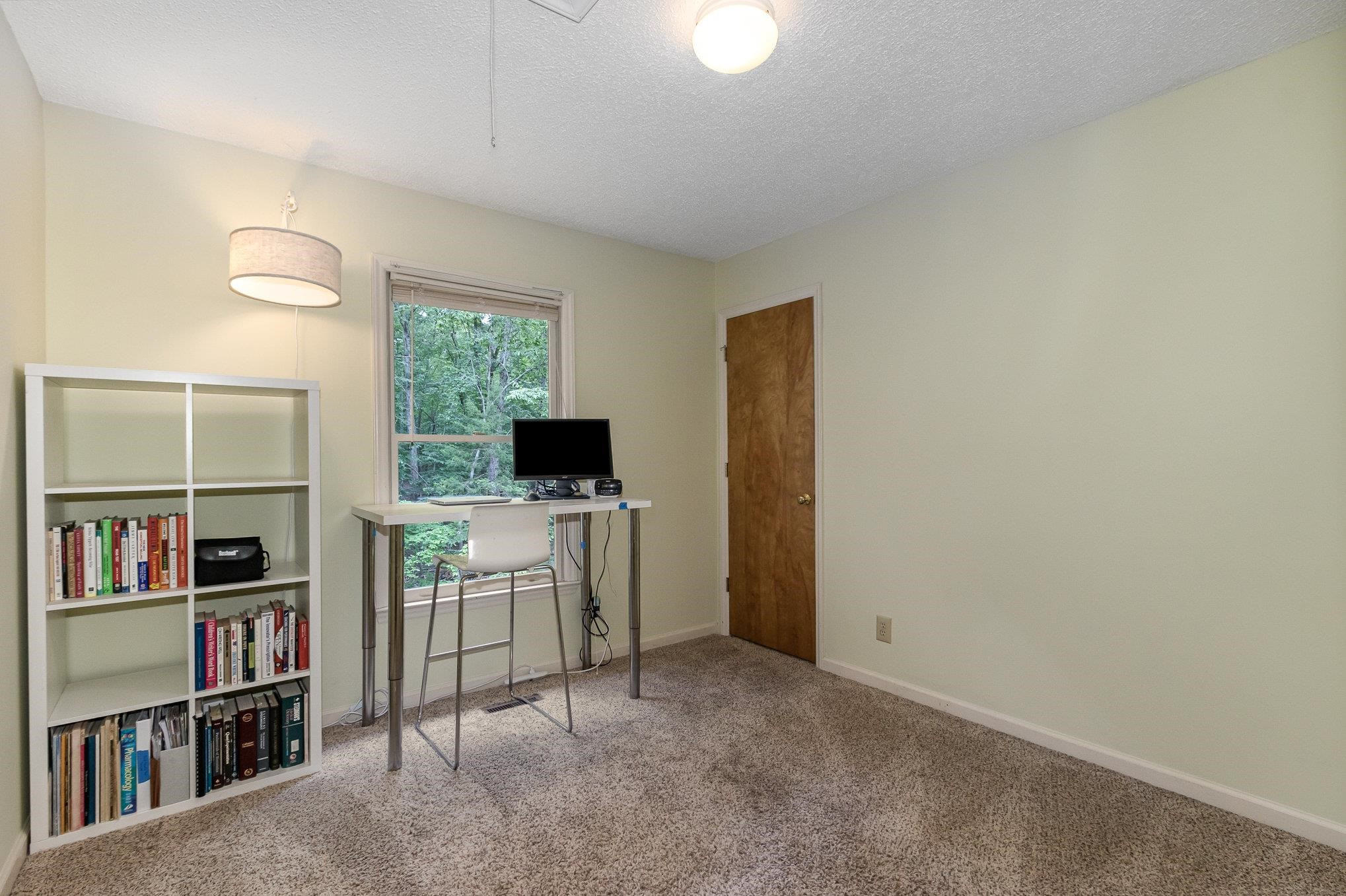 3200 Twin Streams Road Chapel Hill, NC 27516 - Photo 22 of 46 a view of a livingroom with furniture and a bookshelf
