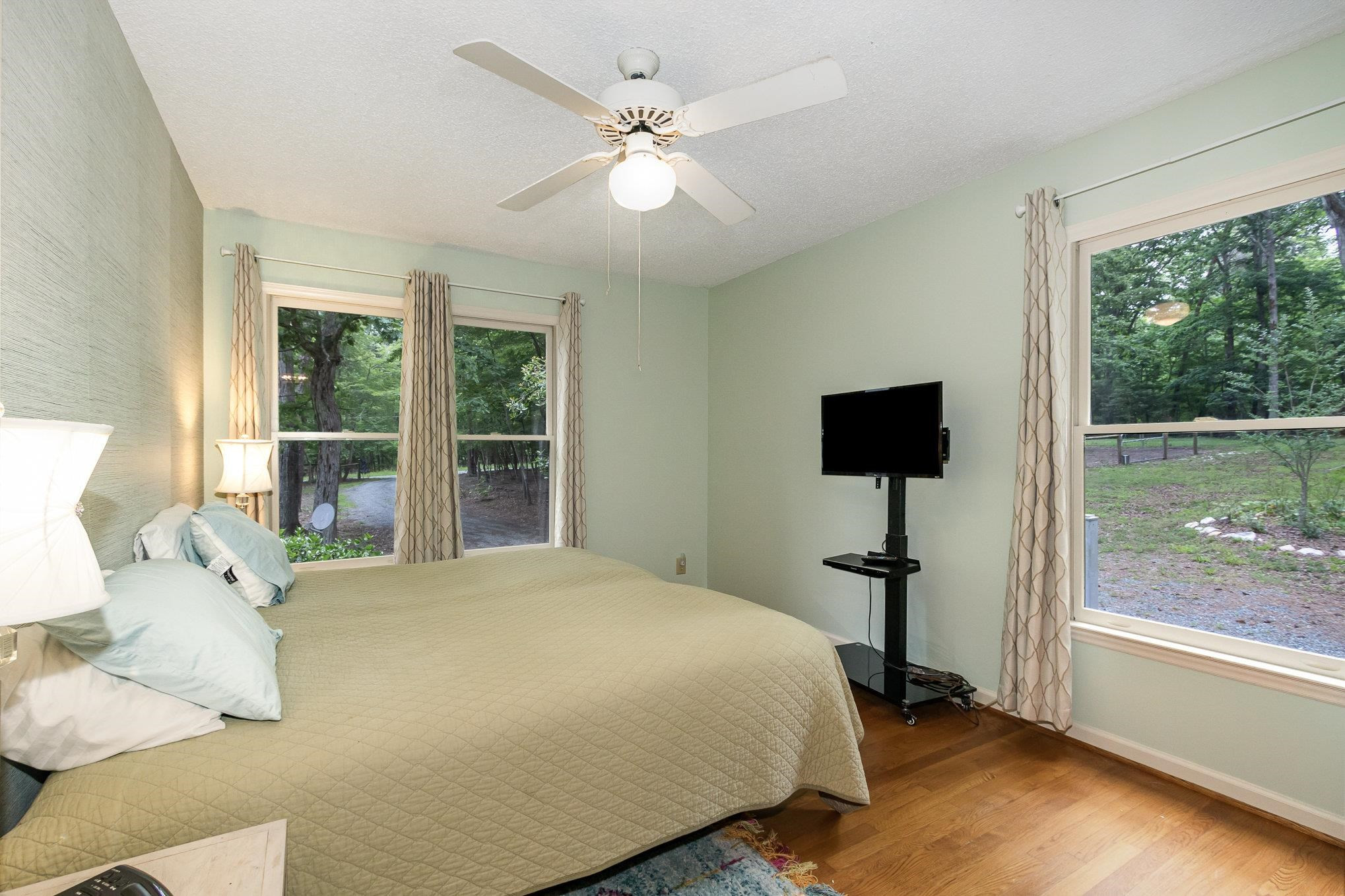 3200 Twin Streams Road Chapel Hill, NC 27516 - Photo 23 of 46 a spacious bedroom with a bed and a large window