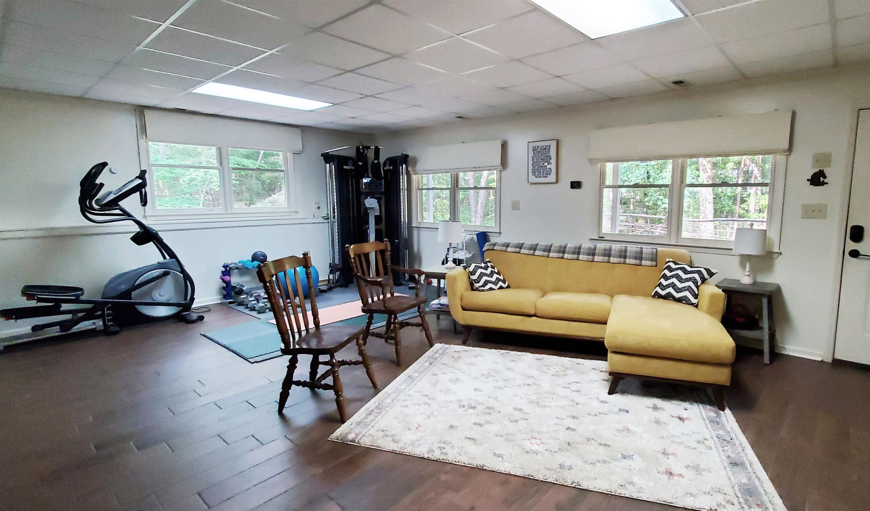 3200 Twin Streams Road Chapel Hill, NC 27516 - Photo 26 of 46 a living room with furniture gym equipment and a large window